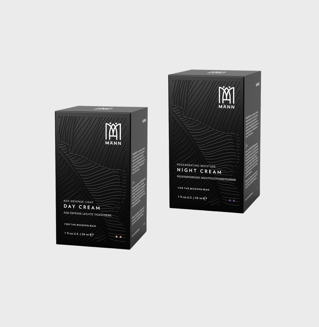 Two black boxes labeled 'Day Cream' and 'Night Cream' with MÄNN Skincare brand logo on a light gray background.